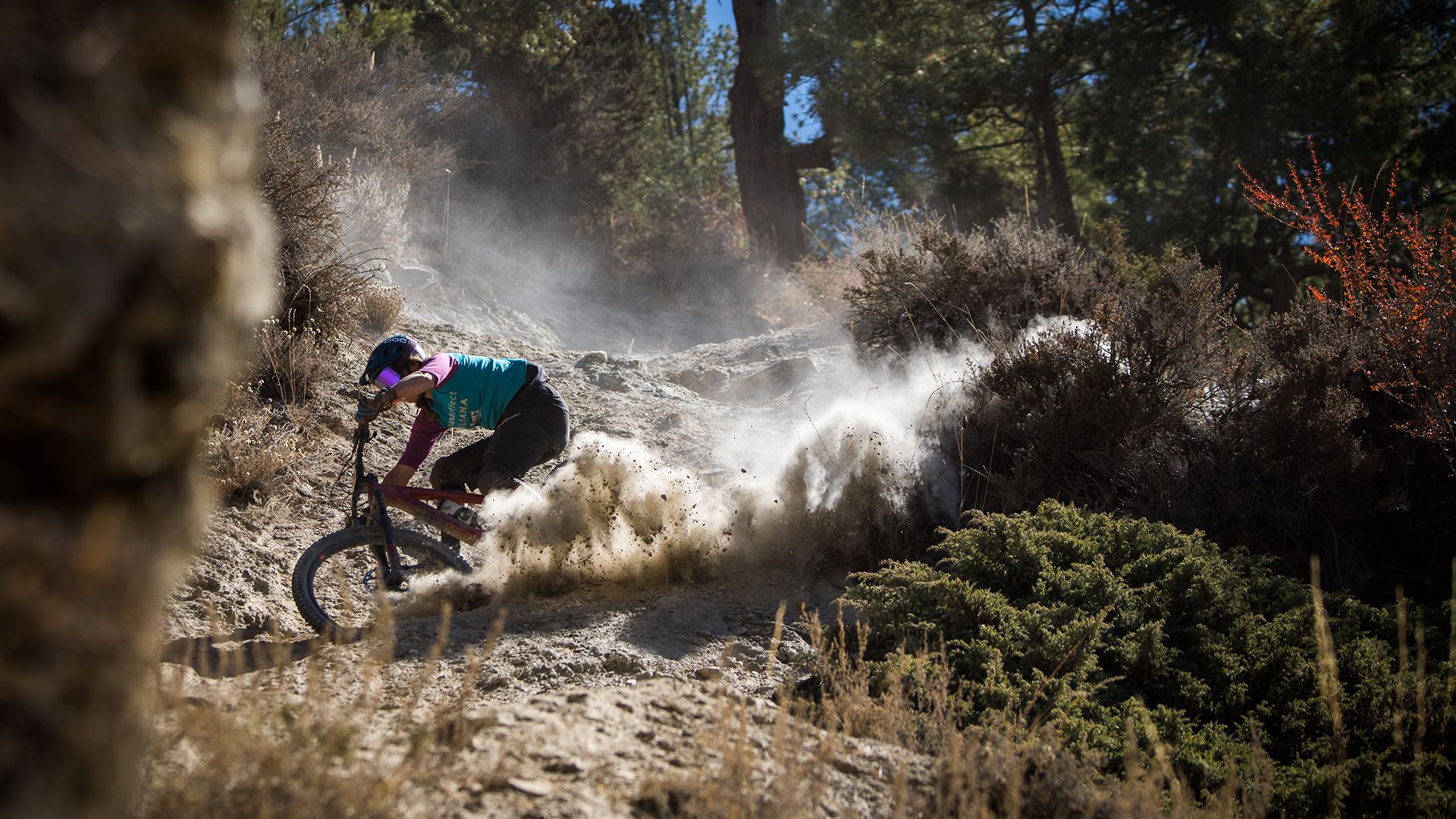 Robin Pieper kicking up dust on a forest trail